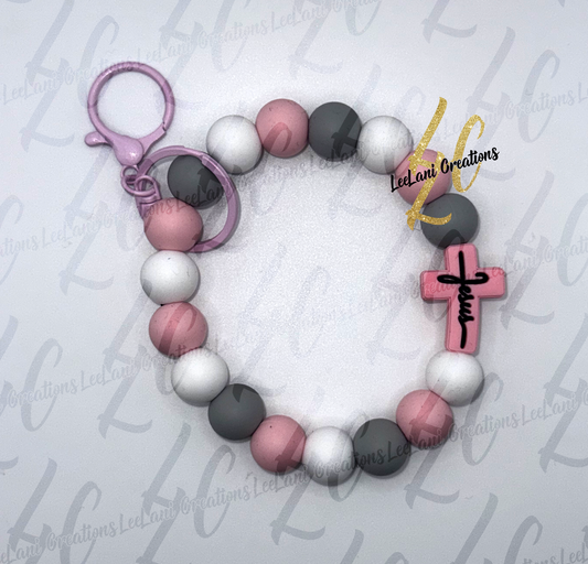 Handmade pink gray and white silicone bead wristlet keychain with Jesus cross focal bead and pink lobster claw clasp